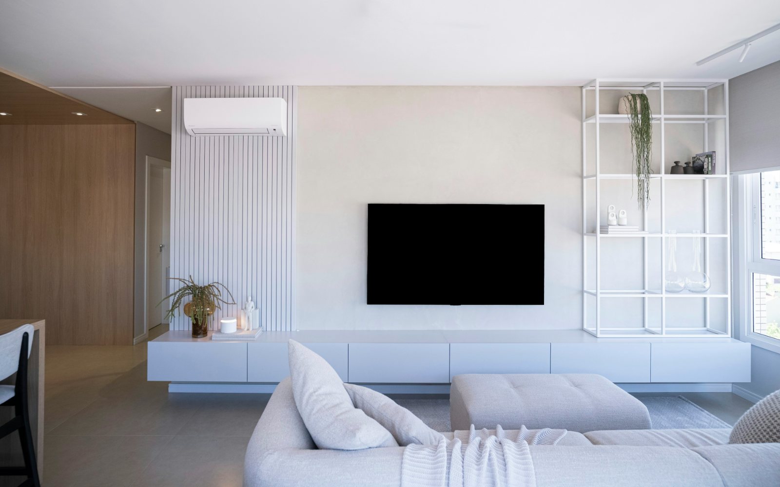 SastaTV IPTV playing on a wall-mounted TV in a bright modern living room